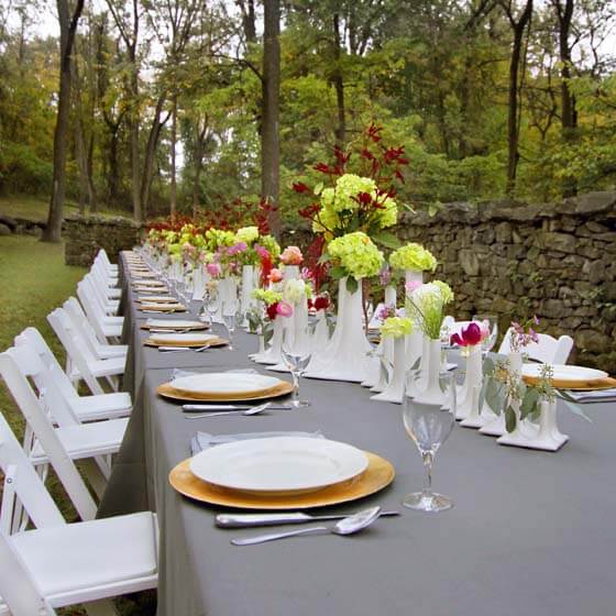 outdoor wedding tablescape with white ceramic vases